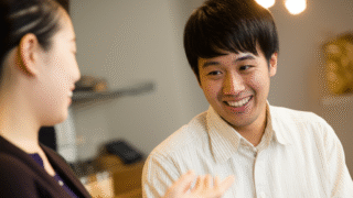 ビジネスミーティング中に話している男性と女性の二人の姿。